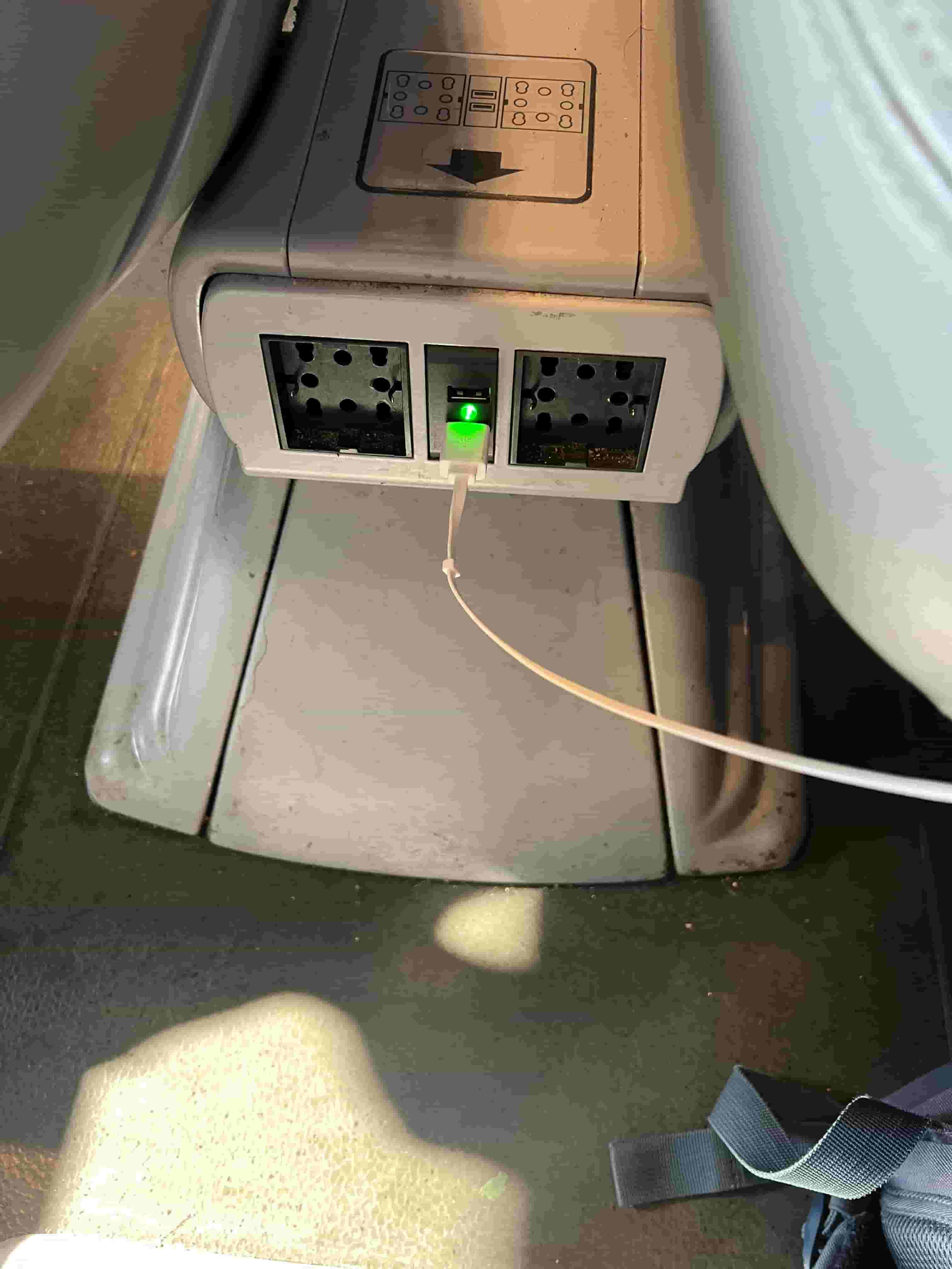 A plug socket and USB port on a train between Venice and Rome in Italy